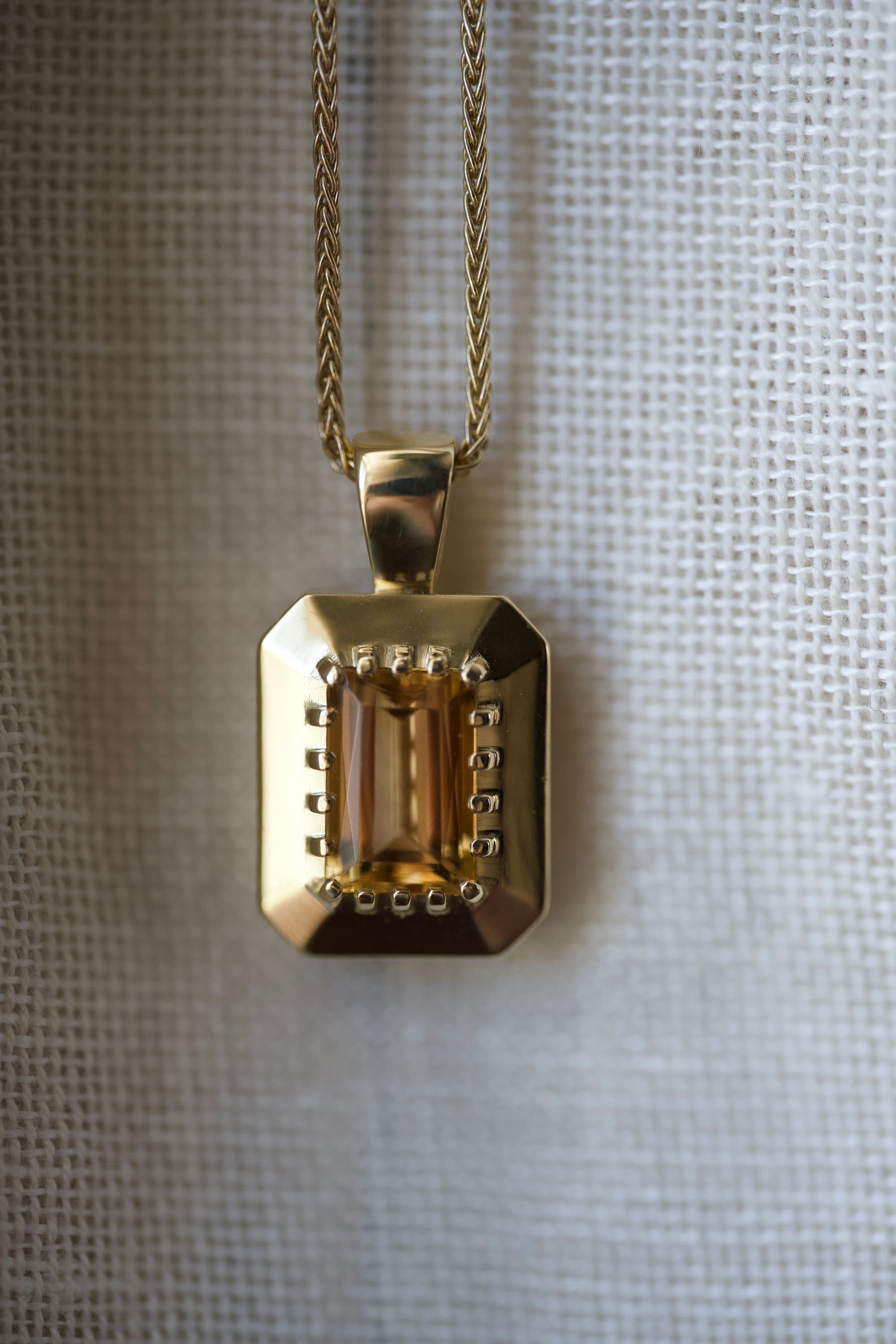 Bespoke gold rectangular pendant featuring an emerald-cut citrine within a beaded frame