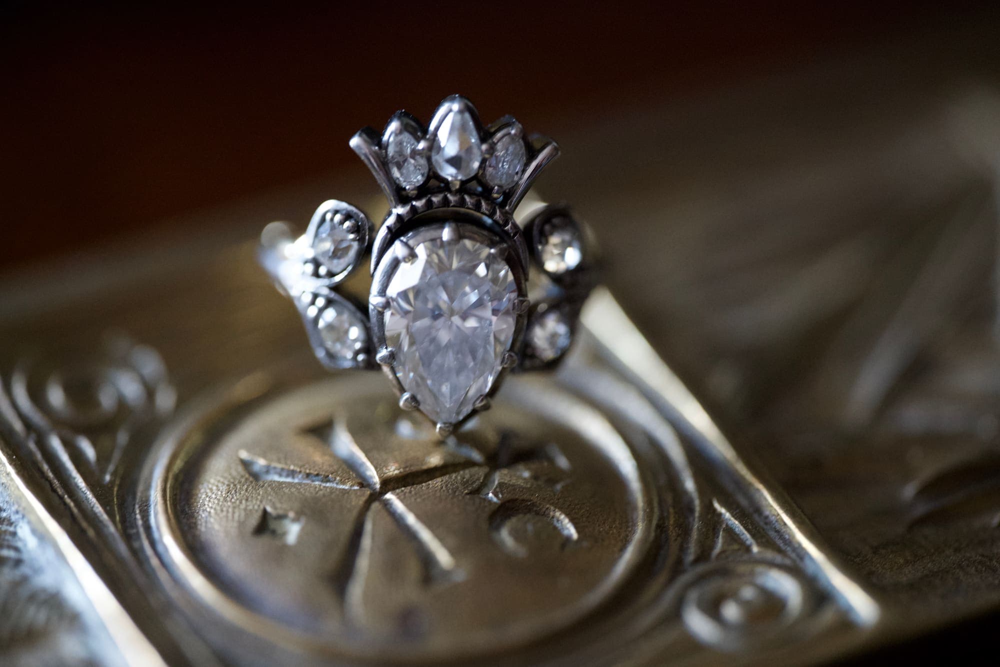 Bespoke crown-form ring with a marquise diamond centre and pear and round accents